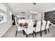 Bright dining area with a dark wood table and white chairs, open to kitchen at 6530 Stoller Ave, Windermere, FL 34786