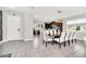 Open concept dining area with dark wood table and white chairs, kitchen view at 6530 Stoller Ave, Windermere, FL 34786