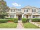 Two-story townhome with a landscaped front yard and brick walkway at 6530 Stoller Ave, Windermere, FL 34786