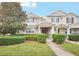 Two-story townhome with a landscaped front yard and brick walkway at 6530 Stoller Ave, Windermere, FL 34786