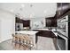 Modern kitchen with dark cabinetry, a large island, and stainless steel appliances at 6530 Stoller Ave, Windermere, FL 34786