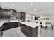 Open concept kitchen with island, stainless steel appliances, and breakfast bar at 6530 Stoller Ave, Windermere, FL 34786