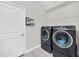 Laundry room with washer, dryer, and storage shelving at 6530 Stoller Ave, Windermere, FL 34786