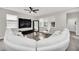 Spacious living room with white sectional sofa and large TV at 6530 Stoller Ave, Windermere, FL 34786