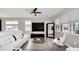 Living room boasts white sectional sofa, large TV, and lots of natural light at 6530 Stoller Ave, Windermere, FL 34786
