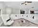 Living room with sectional sofa and large windows offering natural light at 6530 Stoller Ave, Windermere, FL 34786