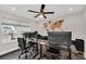 Home office with two desks, multiple monitors, and world map art at 6530 Stoller Ave, Windermere, FL 34786