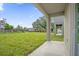 Covered patio overlooks a grassy backyard at 661 Lincoln St, Kissimmee, FL 34741