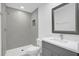 Modern bathroom with gray vanity and shower at 661 Lincoln St, Kissimmee, FL 34741
