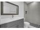 Modern bathroom with gray vanity and tile shower at 661 Lincoln St, Kissimmee, FL 34741
