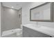 Modern bathroom with gray vanity and shower at 661 Lincoln St, Kissimmee, FL 34741