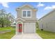 Two-story house with a red door and white garage at 661 Lincoln St, Kissimmee, FL 34741