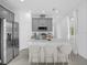 Modern kitchen with gray cabinets and island at 661 Lincoln St, Kissimmee, FL 34741