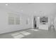 Open living room and kitchen with gray tile floor at 661 Lincoln St, Kissimmee, FL 34741