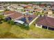 Aerial view showcasing a home with solar panels and a screened patio at 672 San Joaquin Rd, Kissimmee, FL 34759