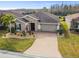 Aerial view of single-story house with solar panels and landscaped yard at 672 San Joaquin Rd, Kissimmee, FL 34759
