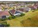 Aerial view of houses with solar panels and lush landscaping at 672 San Joaquin Rd, Kissimmee, FL 34759