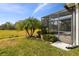 Screened patio and backyard with lush landscaping at 672 San Joaquin Rd, Kissimmee, FL 34759