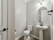 Simple half bathroom with pedestal sink and toilet at 672 San Joaquin Rd, Kissimmee, FL 34759