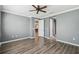 Bedroom with gray walls, wood-look flooring, and ceiling fan at 672 San Joaquin Rd, Kissimmee, FL 34759