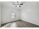 Spacious bedroom featuring wood floors and a large window at 672 San Joaquin Rd, Kissimmee, FL 34759