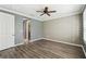 Bedroom with gray walls, wood-look flooring, and neutral-toned wall paper at 672 San Joaquin Rd, Kissimmee, FL 34759