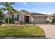 One story home with a two-car garage and landscaping at 672 San Joaquin Rd, Kissimmee, FL 34759