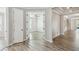 Bright hallway with wood-look floors and an open doorway at 672 San Joaquin Rd, Kissimmee, FL 34759