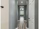 Gray-walled hallway with wood-look flooring leading to bedrooms at 672 San Joaquin Rd, Kissimmee, FL 34759