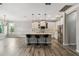 Open kitchen with white cabinets, island, and wood-look floors at 672 San Joaquin Rd, Kissimmee, FL 34759