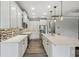 Spacious kitchen with white cabinets, quartz countertops, and tile backsplash at 672 San Joaquin Rd, Kissimmee, FL 34759