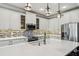 Modern kitchen with white cabinets, quartz countertops, and island at 672 San Joaquin Rd, Kissimmee, FL 34759