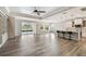 Large living area with hardwood floors and access to a back patio at 672 San Joaquin Rd, Kissimmee, FL 34759