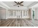 Living room with built-in shelving, hardwood floors, and a ceiling fan at 672 San Joaquin Rd, Kissimmee, FL 34759
