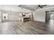 Open living room with vinyl plank flooring and a view of the kitchen at 672 San Joaquin Rd, Kissimmee, FL 34759