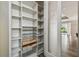 Walk-in pantry with ample shelving and pull-out drawers at 672 San Joaquin Rd, Kissimmee, FL 34759