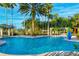 Resort-style pool with palm trees and lounge chairs at 672 San Joaquin Rd, Kissimmee, FL 34759