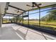 Spacious screened porch with ceiling fans, overlooking backyard at 672 San Joaquin Rd, Kissimmee, FL 34759