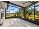 Large screened patio with a view of lush green scenery at 672 San Joaquin Rd, Kissimmee, FL 34759