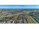 Aerial view of a residential neighborhood with houses and a highway at 8077 Roaring Creek Ct, Kissimmee, FL 34747