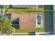 House with brown roof and kidney-shaped pool at 8077 Roaring Creek Ct, Kissimmee, FL 34747