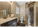 Bathroom with modern vanity, shower, and dark wood-look tile at 8077 Roaring Creek Ct, Kissimmee, FL 34747