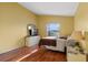Bedroom with wood flooring, a double bed, and a large window at 8077 Roaring Creek Ct, Kissimmee, FL 34747