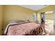 Bright bedroom with wood floors and access to a private bathroom at 8077 Roaring Creek Ct, Kissimmee, FL 34747