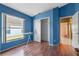 Neat bedroom featuring wood floors and a spacious closet at 8077 Roaring Creek Ct, Kissimmee, FL 34747