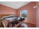 Spacious bedroom with wood floors and a view of the screened-in lanai at 8077 Roaring Creek Ct, Kissimmee, FL 34747