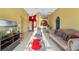 Bright living room featuring a comfortable sofa, armchair, and a large TV at 8077 Roaring Creek Ct, Kissimmee, FL 34747