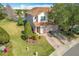 Two-story townhome with a view of the backyard and community lake at 8318 Quimby Cir, Davenport, FL 33896