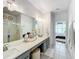 Spacious bathroom with double vanity, large mirror, and walk-in shower at 8318 Quimby Cir, Davenport, FL 33896