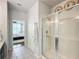 Bathroom with a walk-in shower and view of bedroom at 8318 Quimby Cir, Davenport, FL 33896